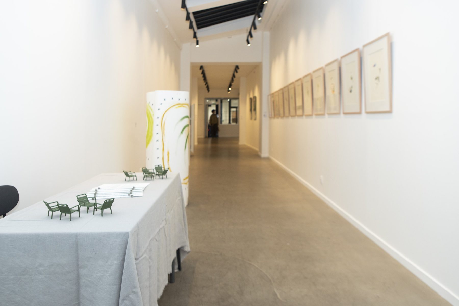 The long skylit gallery at 24 rue Chapon, works hung along both walls.